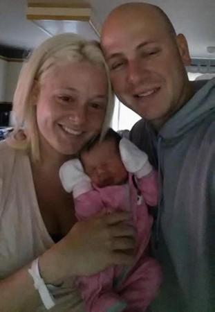 Mélissa McMahon and Simon Boisclair's pose with their day-old girl, Victoria