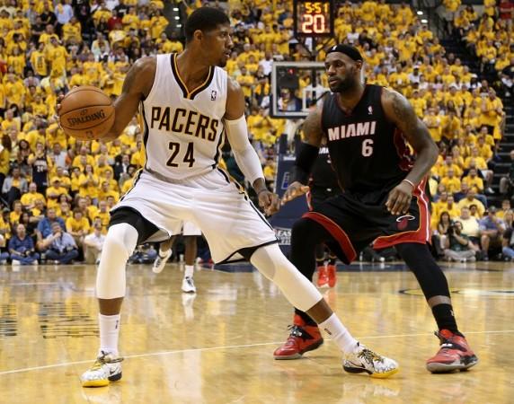 Indiana Pacers' Paul George works around Miami Heat's LeBron James. Paul George Indiana Pacers