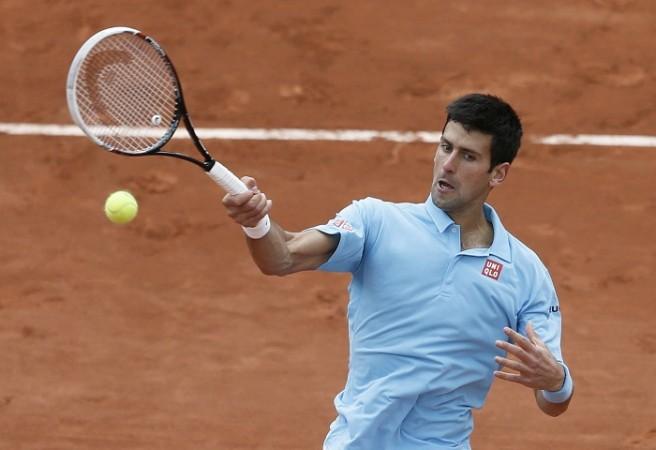 Novak Djokovic returns a forehand to Marin Cilic during their match at the French Open. Novak Djokovic French Open