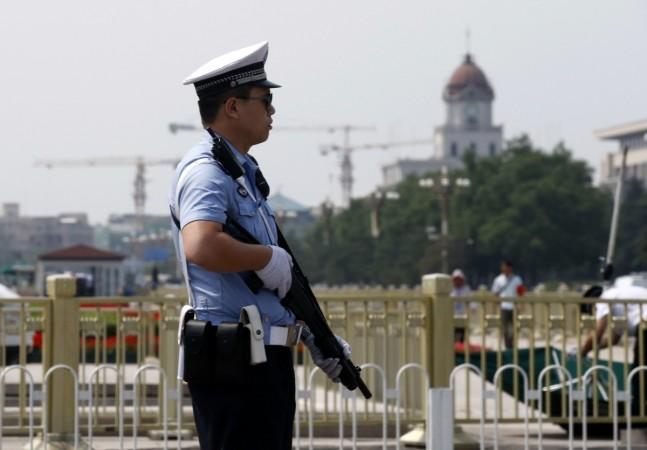 Policeman stands guard with a shotgun in front of Tiananmen Square in Beijing Policeman stands guard with a shotgun in front of Tiananmen Square in Beijing