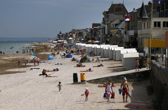 Tourists enjoy the sunshine on the former Juno Beach D-Day landing zone in Saint-Aubin-sur-Mer (Present Day)