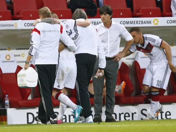 Germany player Reus hobbles off injured next to coach Low during their international friendly soccer match in Mainz Marco Reus and Joachim Low