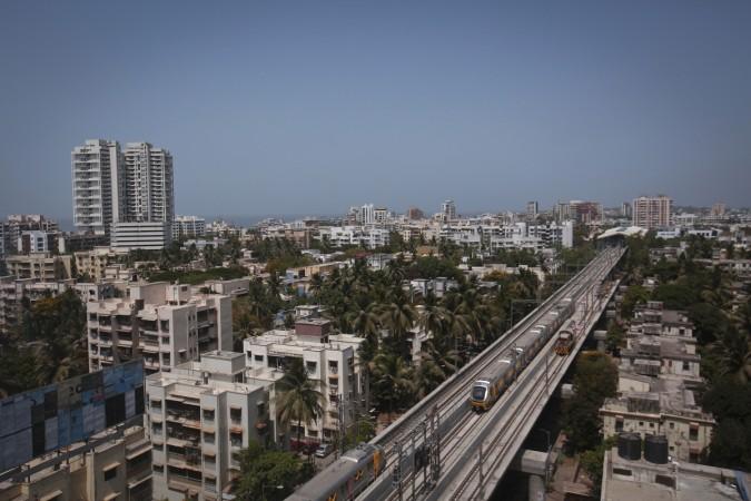 Metro trains pass through a residential area during its first official safety trial run in Mumbai (Reuters, file)