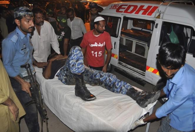 An ASF soldier leads a colleague on a stretcher, who was wounded in an attack at Jinnah International Airport, outside Jinnah hospital in Karachi An ASF soldier leads a colleague on a stretcher, who was wounded in an attack at Jinnah International Airport, outside Jinnah hospital in Karachi