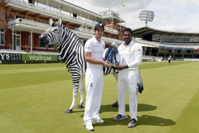 Alastair Cook holds the series trophy with Angelo Mathews before first Test match at Lord's. Alastair Cook and Angelo Mathews