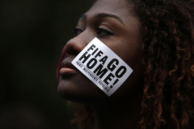 An anti-government demonstrator takes part in a protest against the 2014 World Cup in Rio de Janeiro An anti-government demonstrator takes part in a protest against the 2014 World Cup in Rio de Janeiro