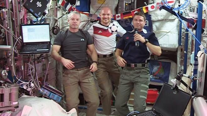 (From left) Expedition 40 Commander Steve Swanson and Flight Engineers Alexander Gerst and Reid Wiseman wish soccer fans and the World Cup 2014 "peaceful games." (NASA TV)