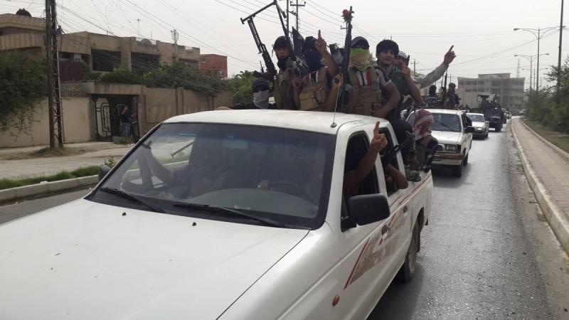 Fighters of the Islamic State in Iraq and the Levant (ISIL) celebrate, on vehicles taken from Iraqi security forces, at a street in city of Mosul Fighters of the Islamic State of Iraq and the Levant (ISIL) celebrate on vehicles taken from Iraqi security forces, at a street in city of Mosul