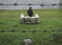 An Indian army soldier stands guard close to the Line of Control, a ceasefire line dividing Kashmir between India and Pakistan, in Poonch