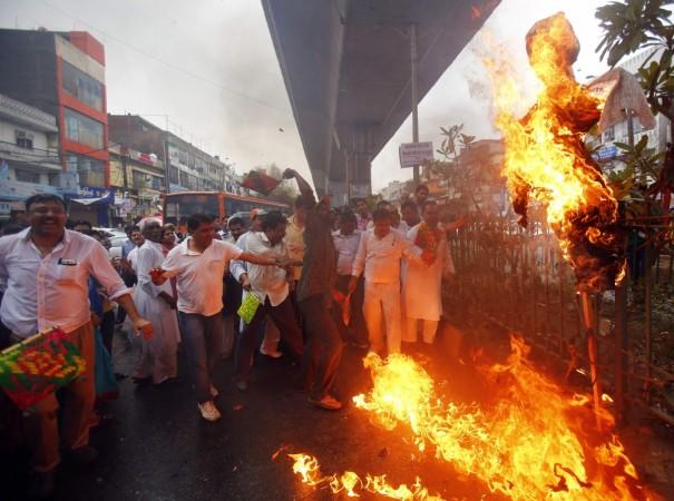 Workers of India's Congress party burn an effigy representing power companies during a protest against power cuts and water problems, in New Delhi Workers of India's Congress party burn an effigy representing power companies during a protest against power cuts and water problems, in New Delhi
