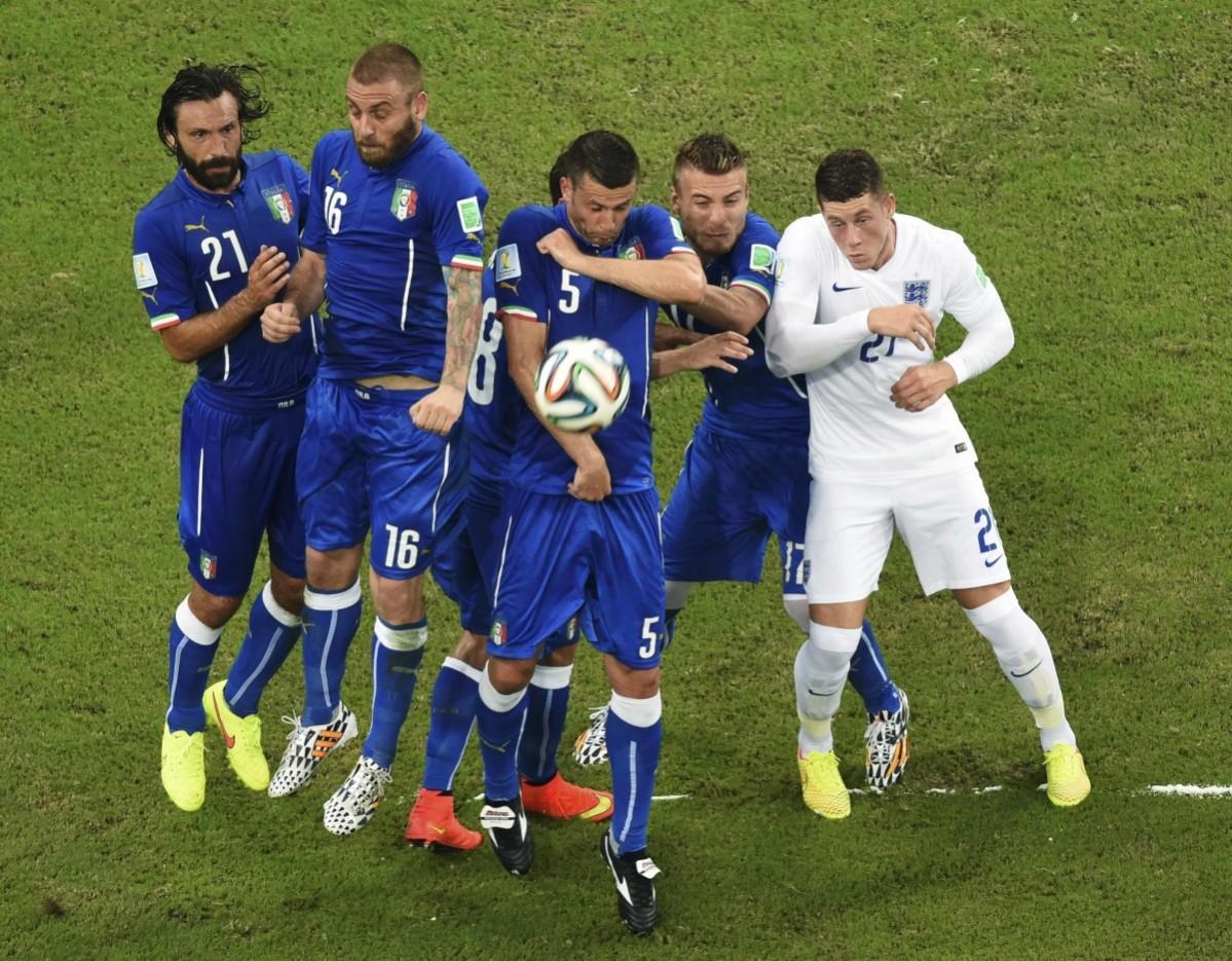 Italy's national soccer players jump to defend an England free kick Italy