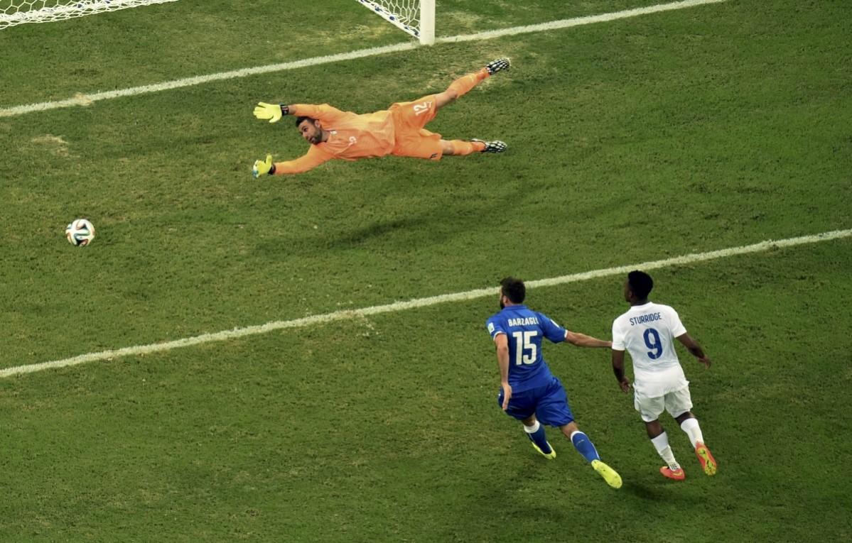 Italy's goalkeeper Sirigu dives for the ball Italy v England