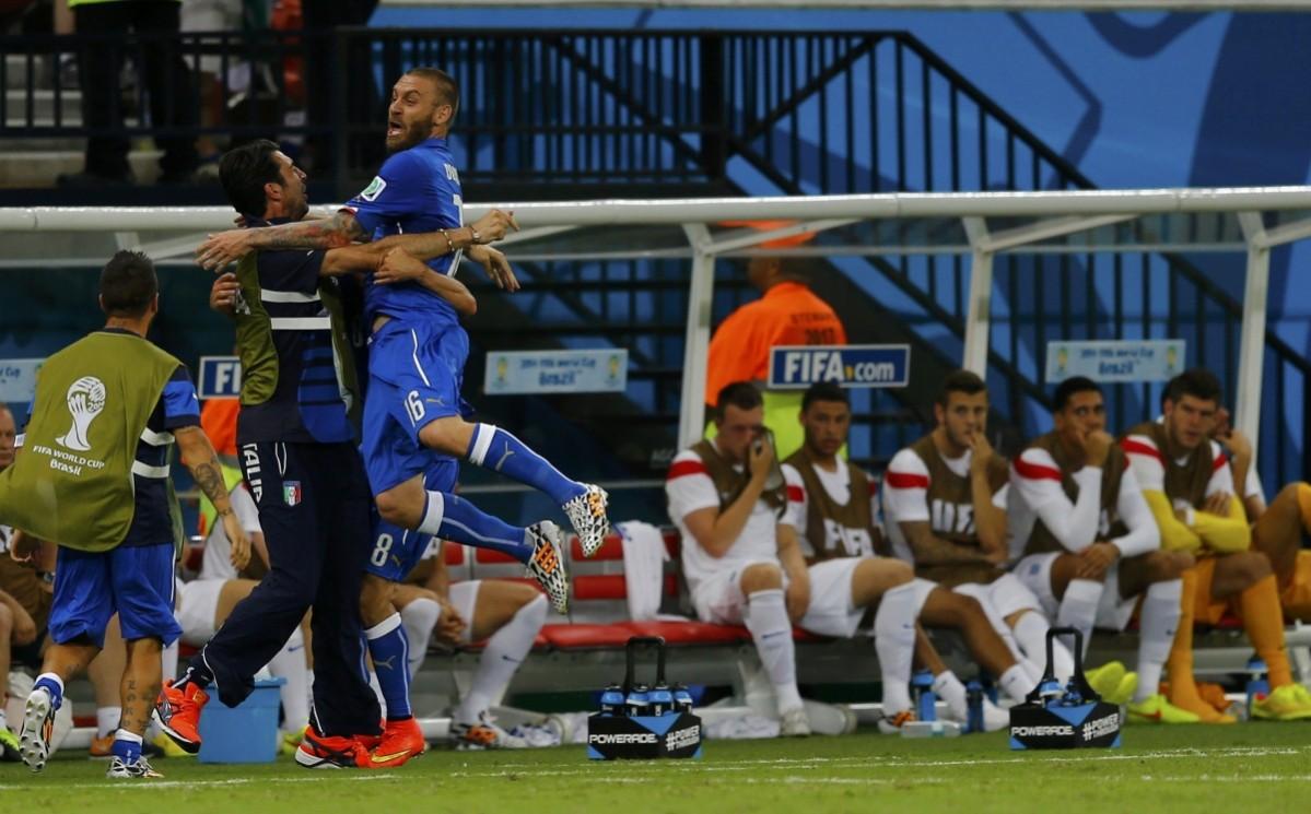 Italy's Marchisio and Itlay's De Rossi celebrate Marchisio's goal in front of the England bench Italy v England