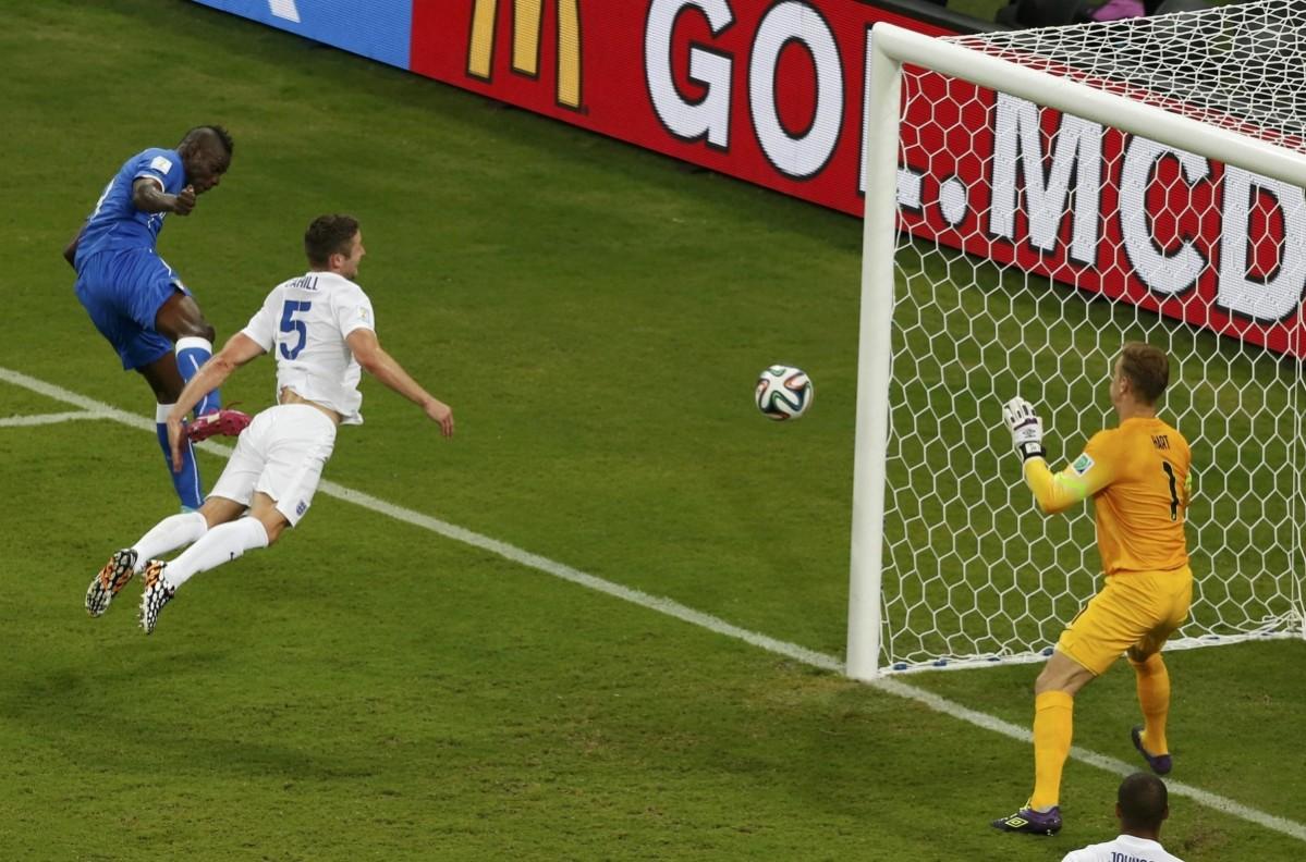 Italy's Balotelli heads the ball to score past England's Cahill and Hart Italy v England