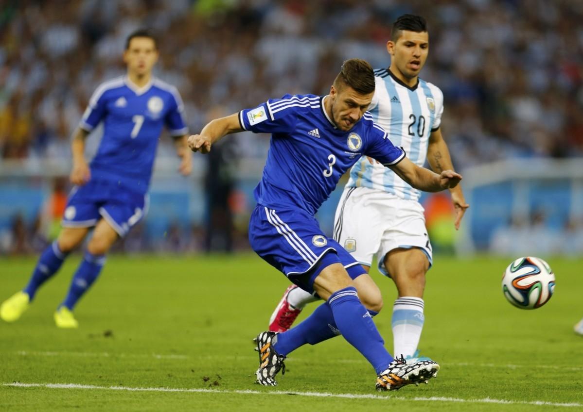 Bosnia's Bicakcic clears the ball away from Argentina's Aguero during their 2014 World Cup Group F soccer match at the Maracana stadium in Rio de Janeiro Argentina vs Bosnia and Herzegovina