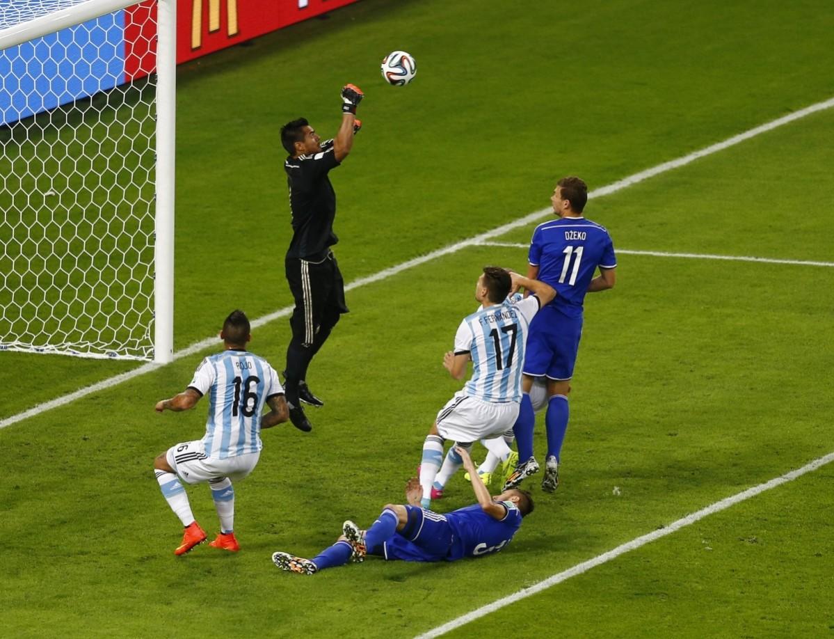 Argentina's goalkeeper Romero makes a save past Bosnia's Dzeko during their 2014 World Cup Group F soccer match at the Maracana stadium in Rio de Janeiro Argentina vs Bosnia and Herzegovina