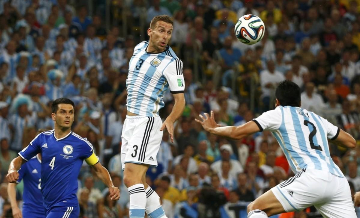 Argentina's Campagnaro reaches for the ball during their 2014 World Cup Group F soccer match against Bosnia at the Maracana stadium in Rio de Janeiro Argentina vs Bosnia and Herzegovina