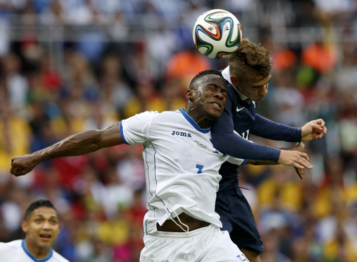 Maynor Figueroa of Honduras and France's Antoine Griezmann jump for the ball during their 2014 World Cup Group E soccer match at the Beira-Rio stadium in Porto Alegre France v Honduras