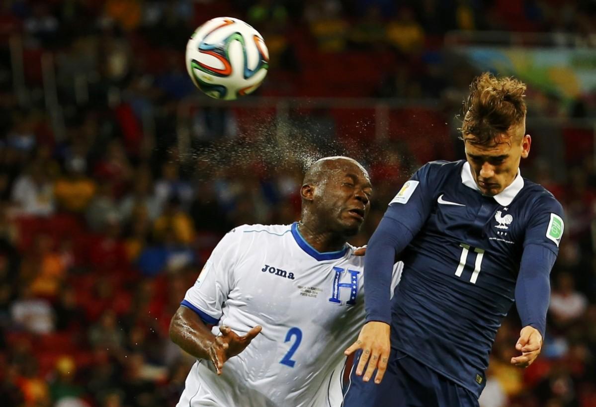 France's Griezmann jumps for the ball with Chavez of Honduras during their 2014 World Cup Group E soccer match at the Beira Rio stadium in Porto Alegre France v Honduras