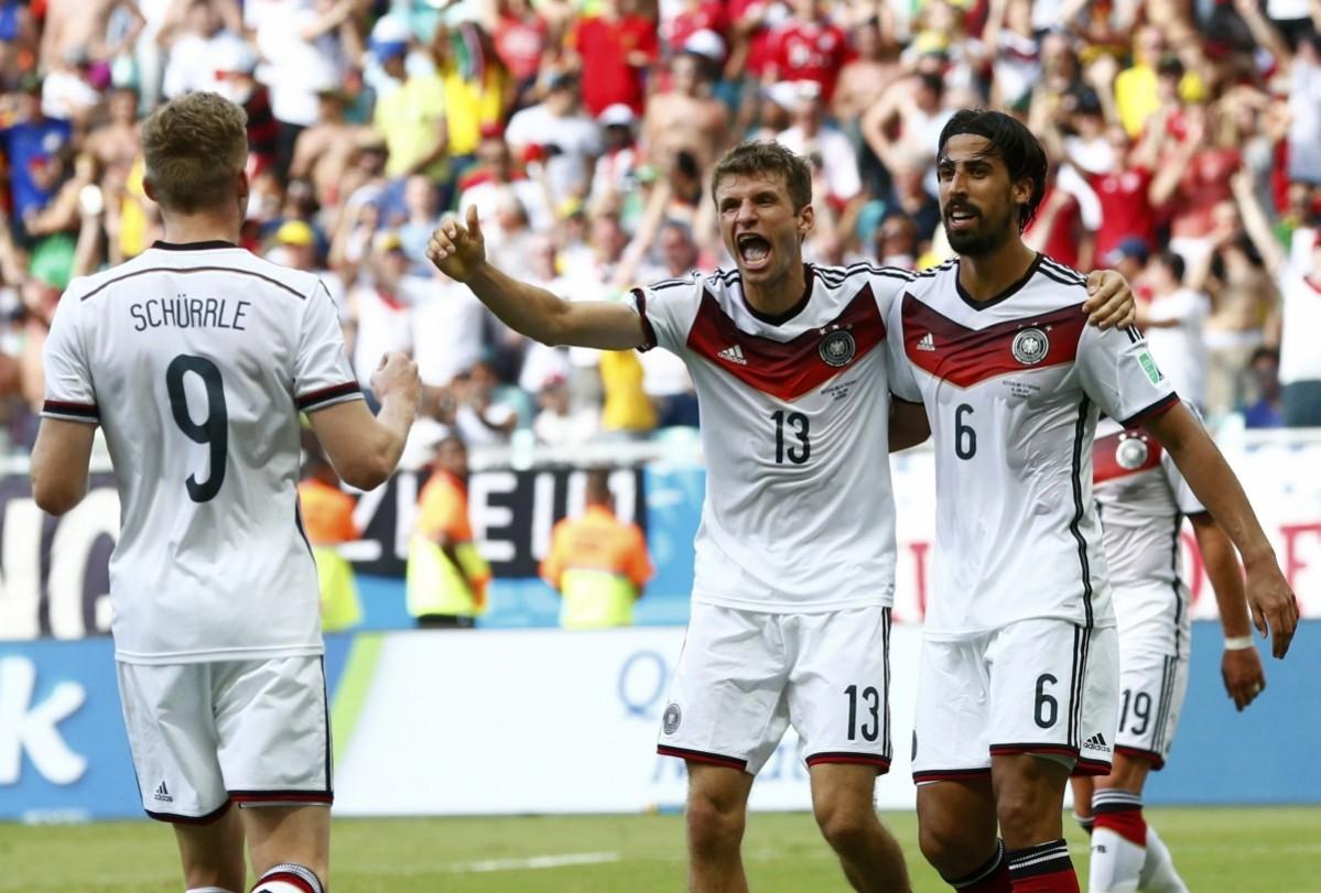 Germany's Andre Schuerrle and Sami Khedira celebrate Thomas Mueller's hat trick during their 2014 World Cup Group G soccer match against Portugal at the Fonte Nova arena in Salvador Germany v Portugal