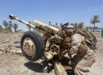 Iraqi security forces fire artillery during clashes with Sunni militant group Islamic State of Iraq and the Levant in in Jurf al-Sakhar