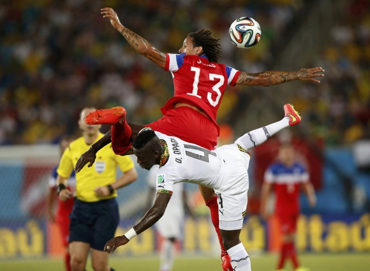 Jermaine Jones of the U.S. jumps for the ball against Ghana's Daniel Opare during their 2014 World Cup Group G soccer match at the Dunas arena in Natal Ghana vs USA