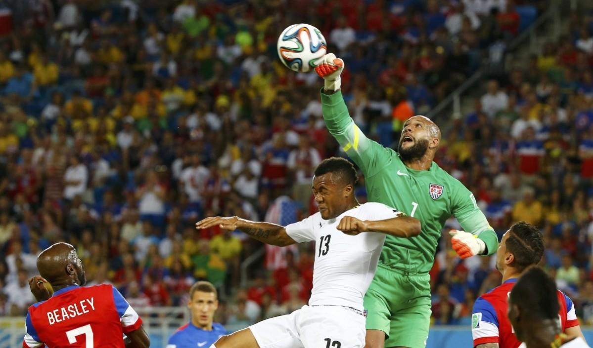 Ghana's Jordan Ayew jumps for the ball with goalkeeper Tim Howard of the U.S. during their 2014 World Cup Group G soccer match at the Dunas arena in Natal Ghana vs USA