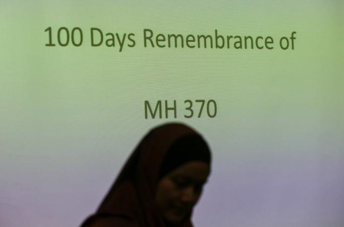 A family member of a Malaysian passenger on board Malaysia Airlines Flight 370 stands near during 100 Days Remembrance of MH370 in Kuala Lumpur