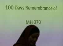 A family member of a Malaysian passenger on board Malaysia Airlines Flight 370 stands near during 100 Days Remembrance of MH370 in Kuala Lumpur