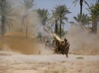 Iraqi security forces fire artillery during clashes with Sunni militant group Islamic State of Iraq and the Levant in Jurf al-Sakhar