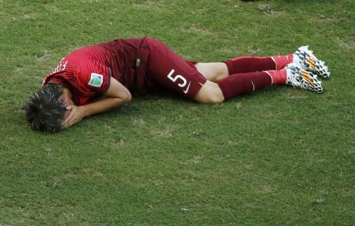 Fabio Coentrao lays on the ground in pain during Portugal's match against Germany. Fabio Coentrao