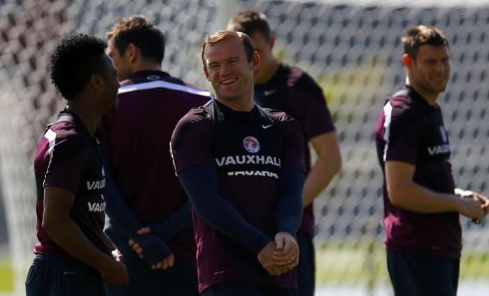 England's Wayne Rooney talks with Raheem Sterling during a training session. Wayne Rooney