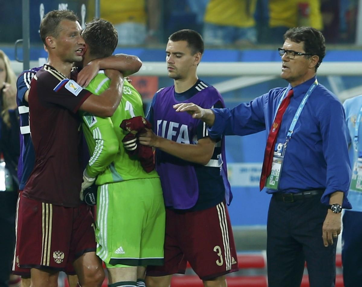 Russia's Akinfeev is comforted by teammates at the end of their 2014 World Cup Group H soccer match against South Korea at the Pantanal arena in Cuiaba Russia v South Korea