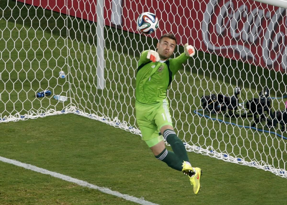 Russia's goalkeeper Igor Akinfeev makes a save during World Cup Group H soccer match at the Pantanal arena Russia v South Korea