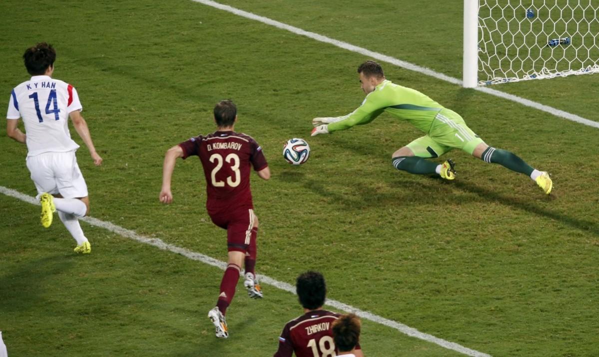 Russia's goalkeeper Igor Akinfeev makes a save during the 2014 World Cup Group H soccer match between Russia and South Korea at the Pantanal arena Russia v South Korea