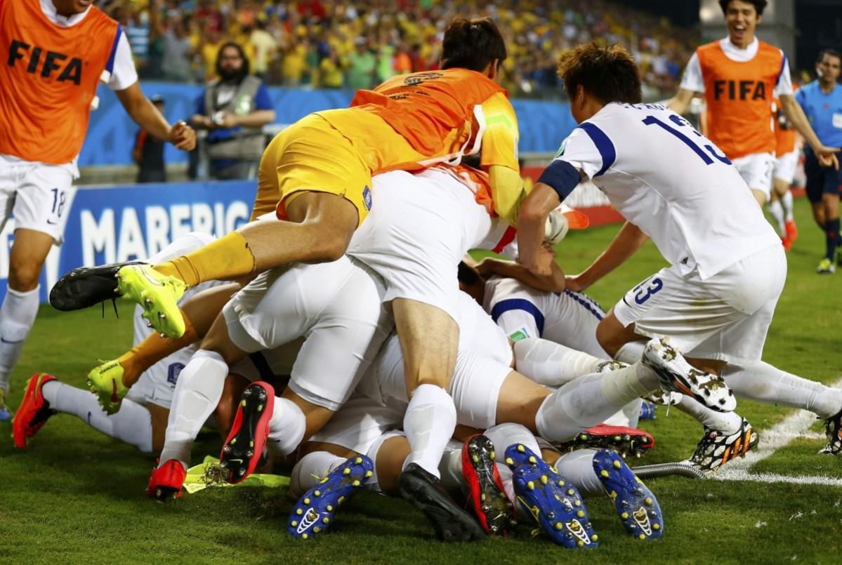 South's Korea's national soccer players pile on top of teammate Keun-ho as they celebrate his goal against Russia during their 2014 World Cup Group H soccer match at the Pantanal arena in Cuiaba Russia v South Korea