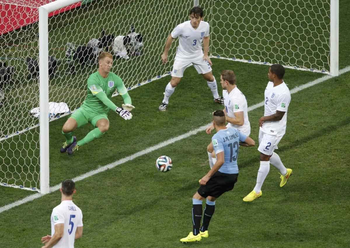 England's Hart dives to intercept a goal attempt from Uruguay's Gimenez during their 2014 World Cup Group D soccer match at the Corinthians arena in Sao Paulo Uruguay v England