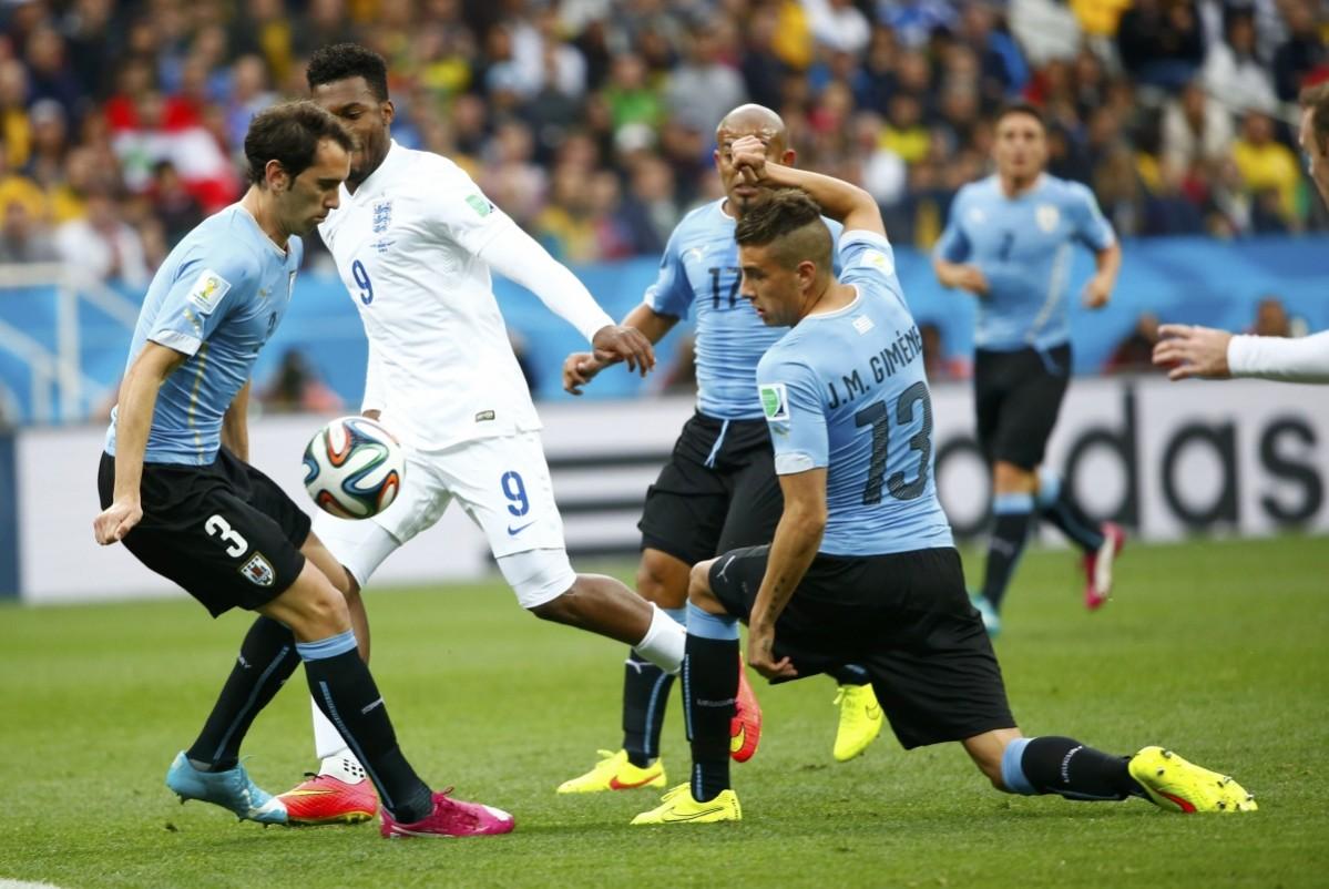 Uruguay's Diego Godin handles the ball during their 2014 World Cup Group D soccer match against England at the Corinthians arena in Sao Paulo Uruguay v England