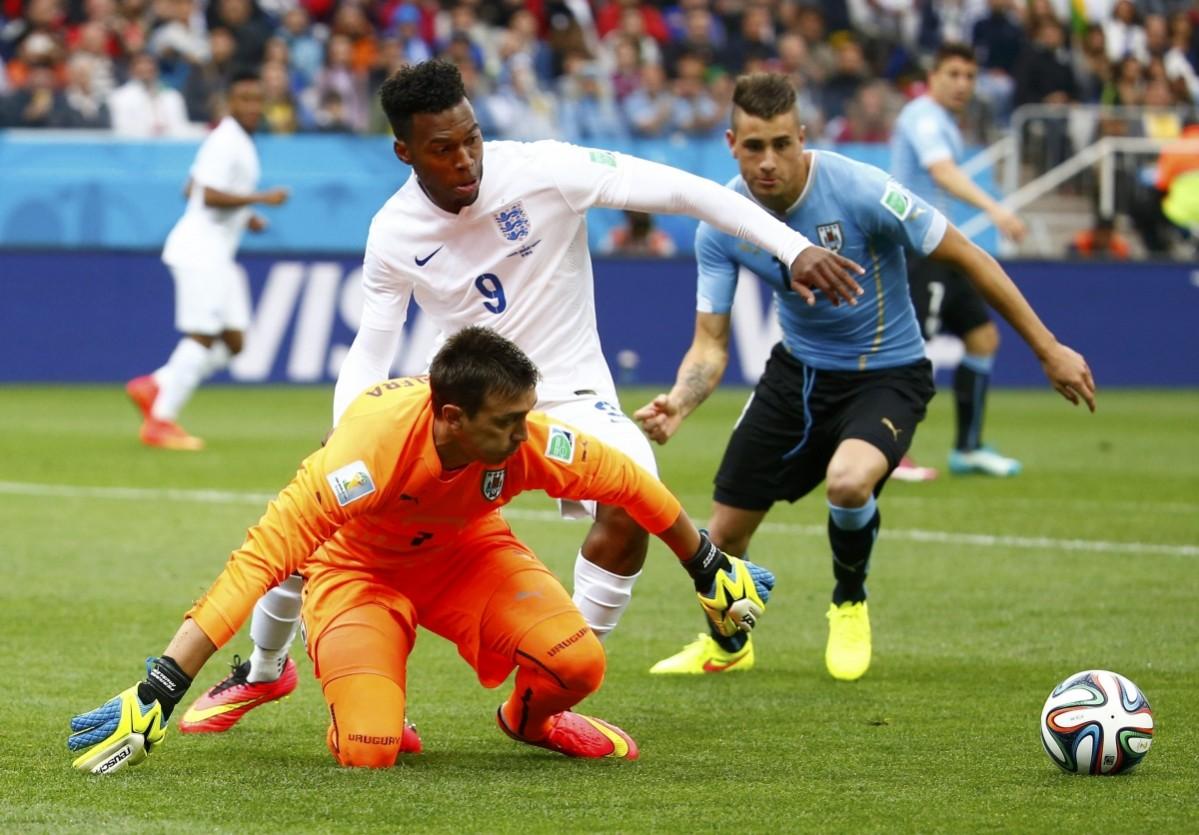 Uruguay's Fernando Muslera fights for the ball with England's Sturridge during their 2014 World Cup Group D soccer match at the Corinthians arena in Sao Paulo Uruguay v Costa Rica