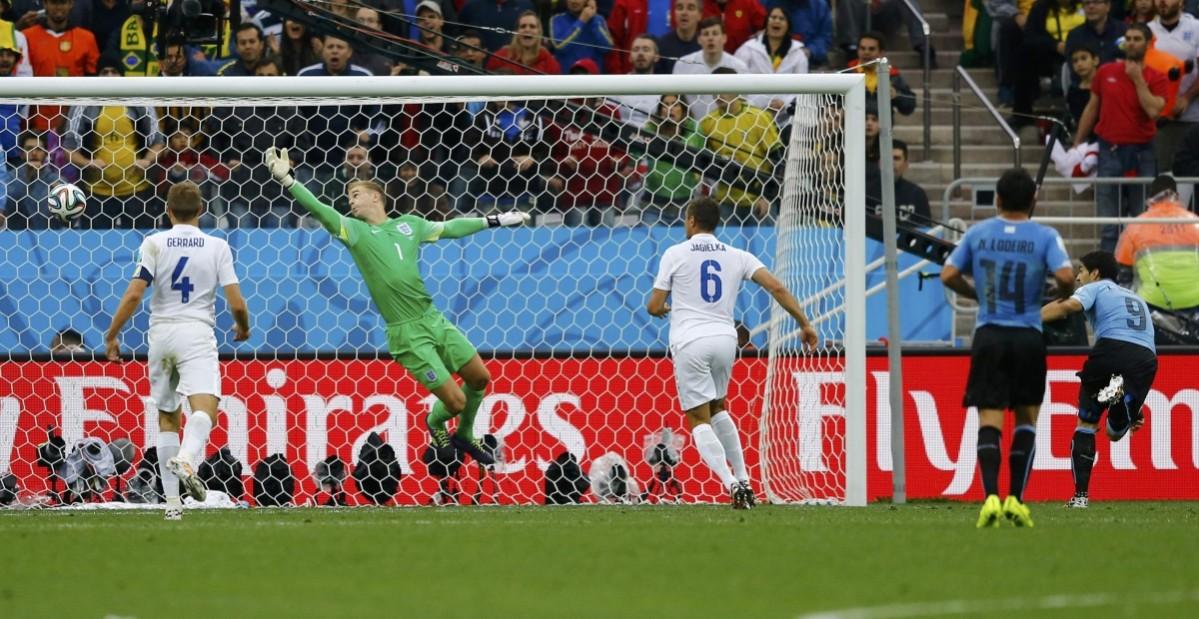 England's Gerrard, Hart and Jagielka watch as they concede a goal to a header by Uruguay's Suarez during their 2014 World Cup Group D soccer match at the Corinthians arena in Sao Paulo Uruguay v England
