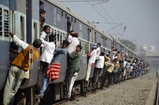 Commuters hang onto a crowded local passenger train in the eastern Indian city of Patna (Reuters file)