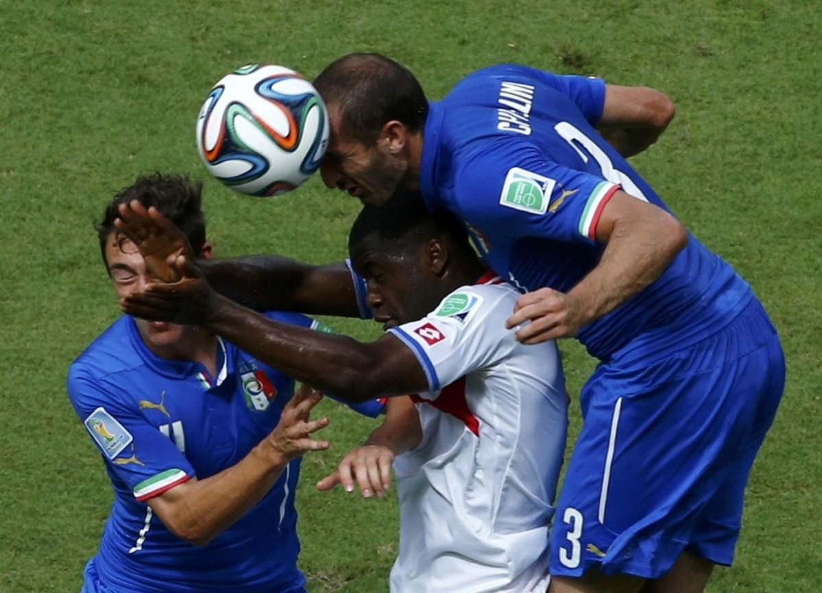Italy's Matteo Darmian and Giorgio Chiellini fights for the ball against Costa Rica's Joel Campbell during their 2014 World Cup Group D soccer match at the Pernambuco arena in Recife Italy vs Costa Rica