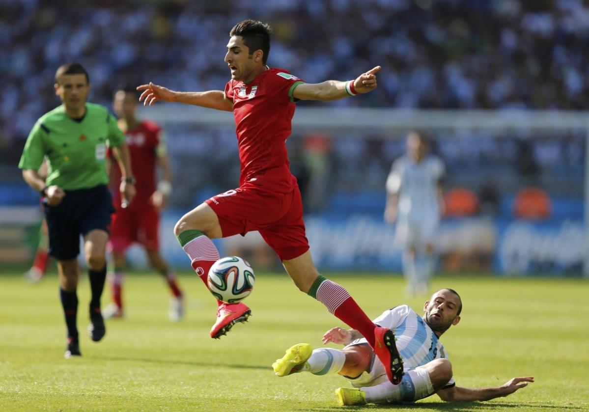 Iran's Jahanbakhsh is challenged by Argentina's Mascherano during their 2014 World Cup Group F match at the Mineirao stadium in Belo Horizonte Argentina vs Iran
