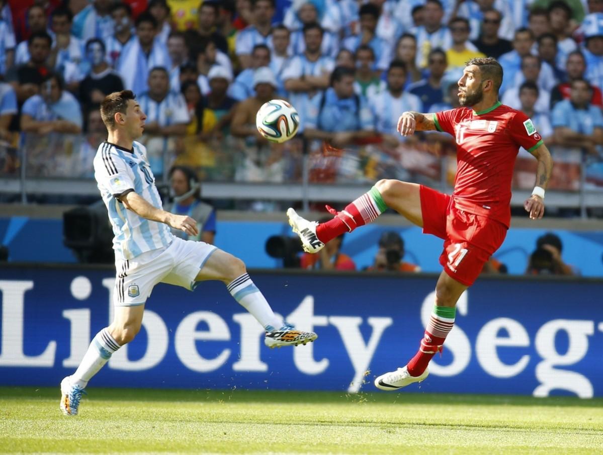 Argentina's Messi fights for the ball with Iran's Dejagah during their 2014 World Cup Group F match at the Mineirao stadium in Belo Horizonte Argentina vs Iran