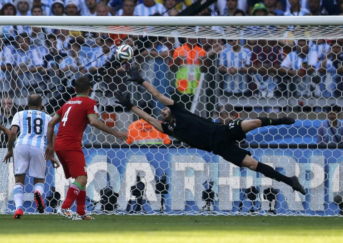 Iran's goalkeeper Haghighi fails to save a goal by Argentina's Messi during their 2014 World Cup Group F match at the Mineirao stadium in Belo Horizonte Argentina vs Iran