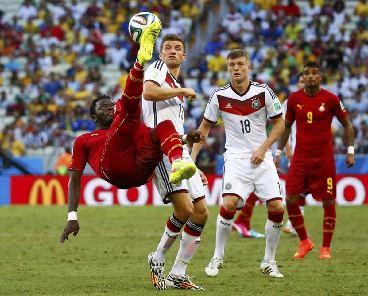Ghana's Muntari clears the ball away from Germany's Mueller and Kroos during their 2014 World Cup Group G match at the Castelao arena in Fortaleza Germany v Ghana