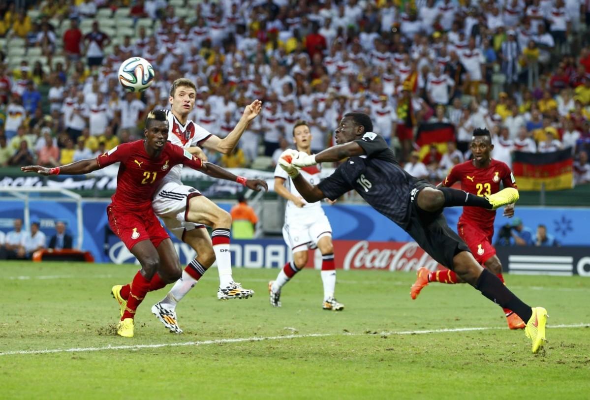 Germany's Thomas Mueller tries to score, as Ghana's John Boye and goalkeeper Fatau Dauda defend, during their 2014 World Cup Group G match at the Castelao arena Germany v Ghana