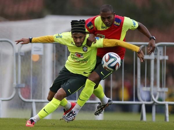 Brazil's Neymar and Fernandinho battle for the ball during a training session. Neymar Practice