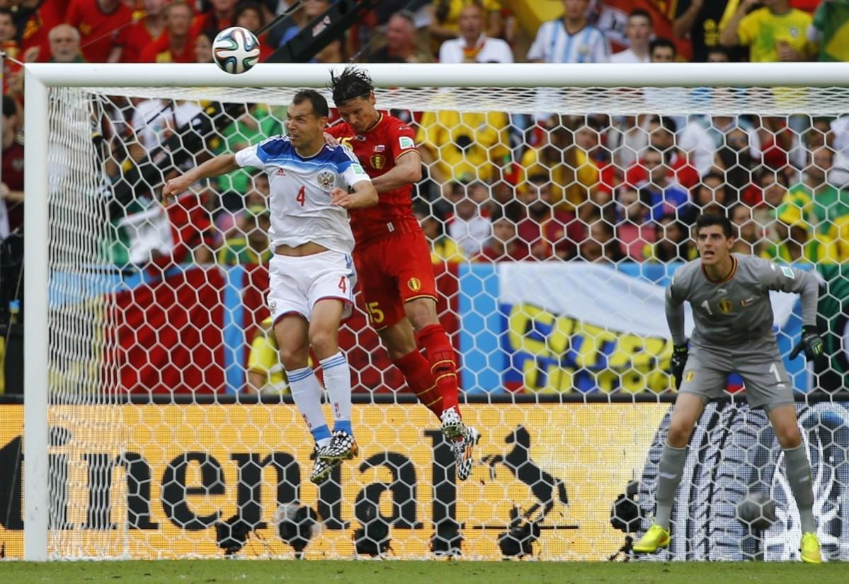 Russia's Ignashevich jumps for the ball with Belgium's Buyten during their 2014 World Cup Group H match at the Maracana stadium in Rio de Janeiro Belgium vs Russia