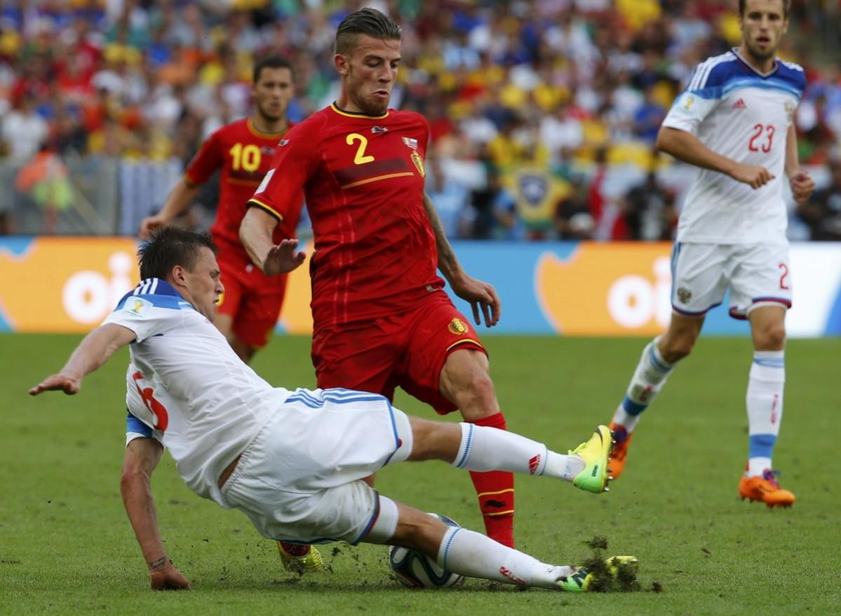 Russia's Kanunnikov tackles Belgium's Alderweireld for the ball during their 2014 World Cup Group H soccer match at the Maracana stadium in Rio de Janeiro Belgium vs Russia